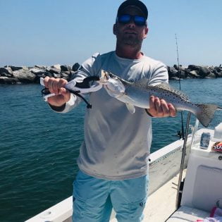 Angler holding a speckled trout