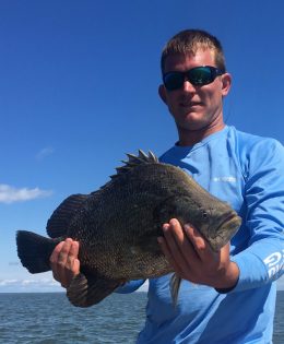 Captain Jared holding a flounder