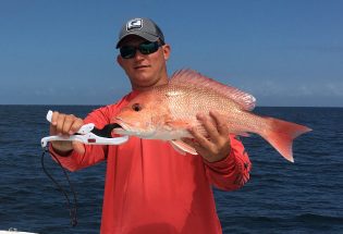 Captain Jared holding a red snapper