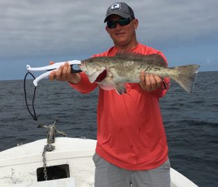 Captain Jared holding the catch of the day