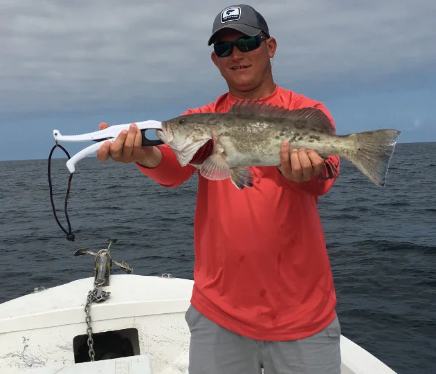 Captain Jared holding the catch of the day Captain Jared holding the catch of the day