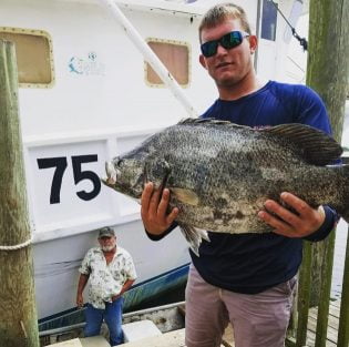 Catpain Jared and Angler with a flounder