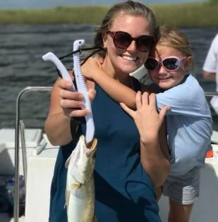 Mother and daughter holding the catch of the day