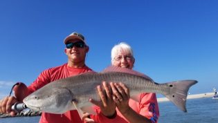 Captain Jared and Angler Holding a Red Fish