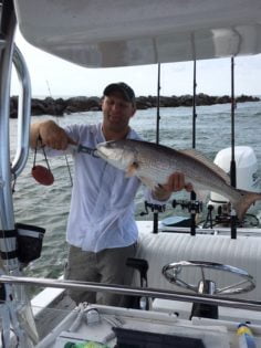 Man holding a Red Fish